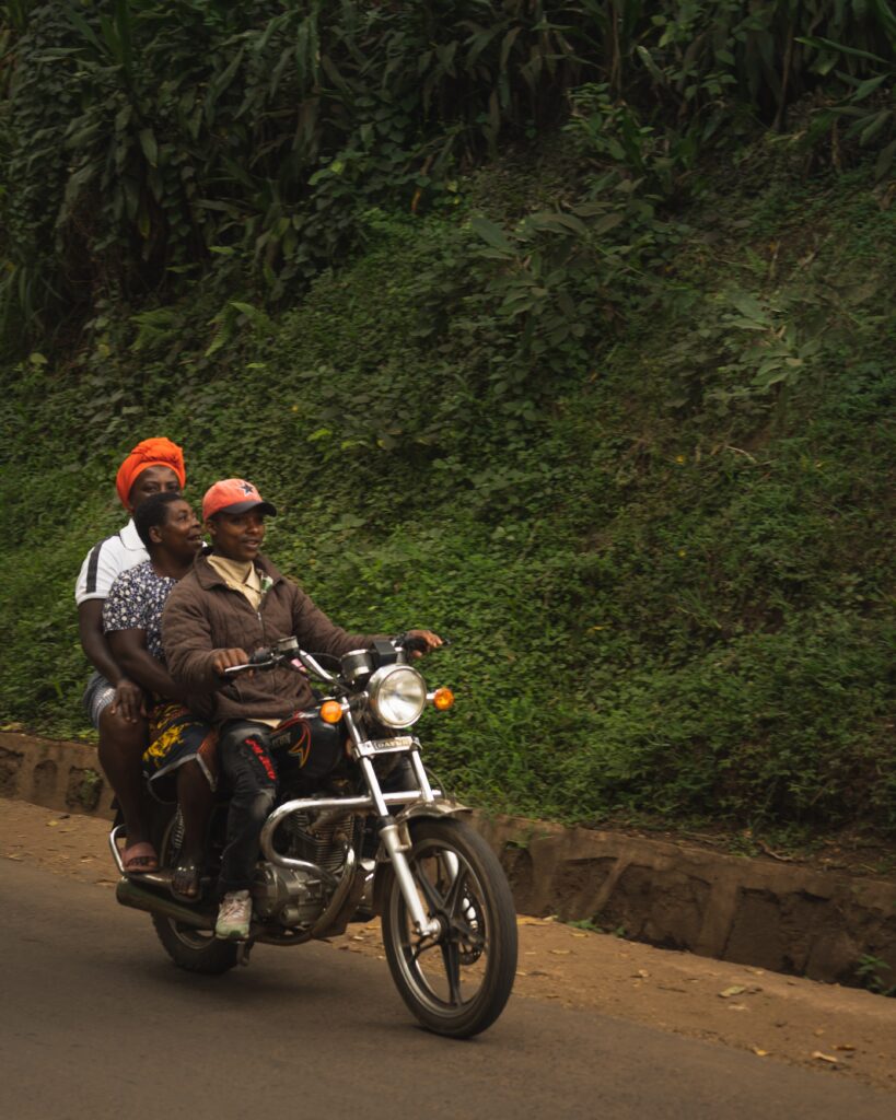 Tanzanians on a motorbike riding through the country